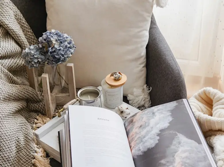 A cosy reading nook with cushions beside a bright window