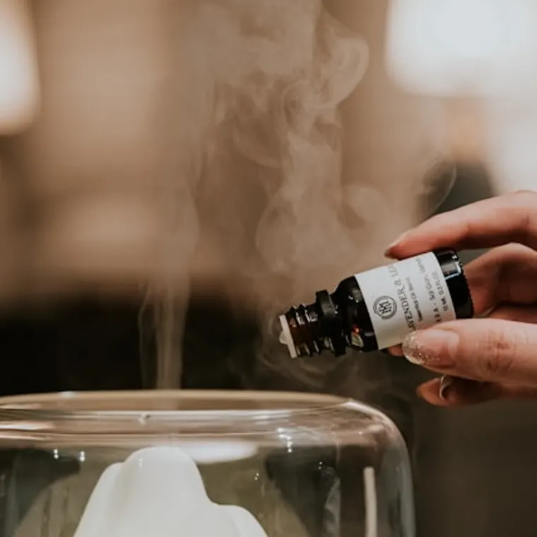 Diffuser being topped up with essential oil