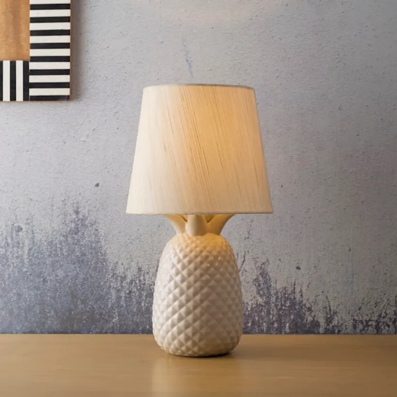 Matte stoneware table lamp casting a warm glow