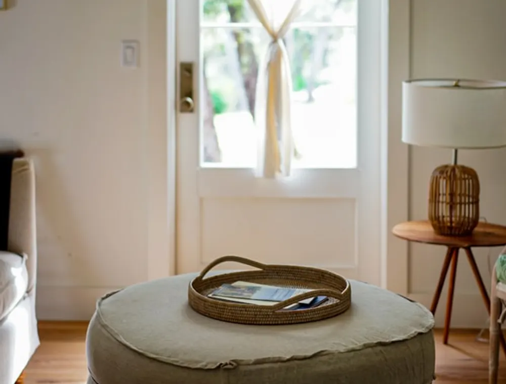 A minimal Japandi living room with a low chair and a potted plant